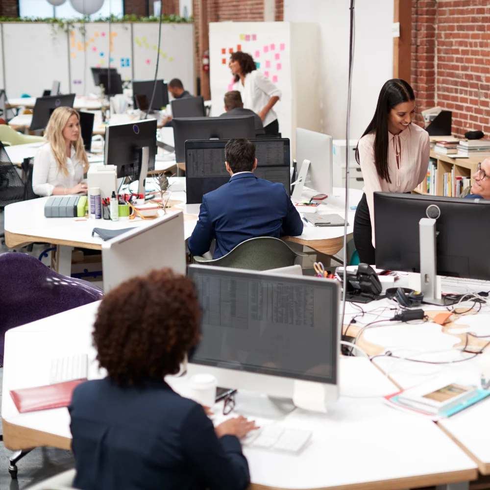 Business Team Working At Desks In Modern Open Plan Office