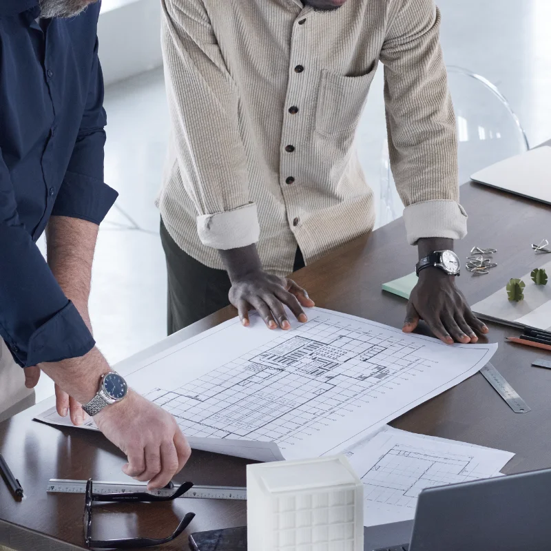 Architects developing a new project at table with blueprints